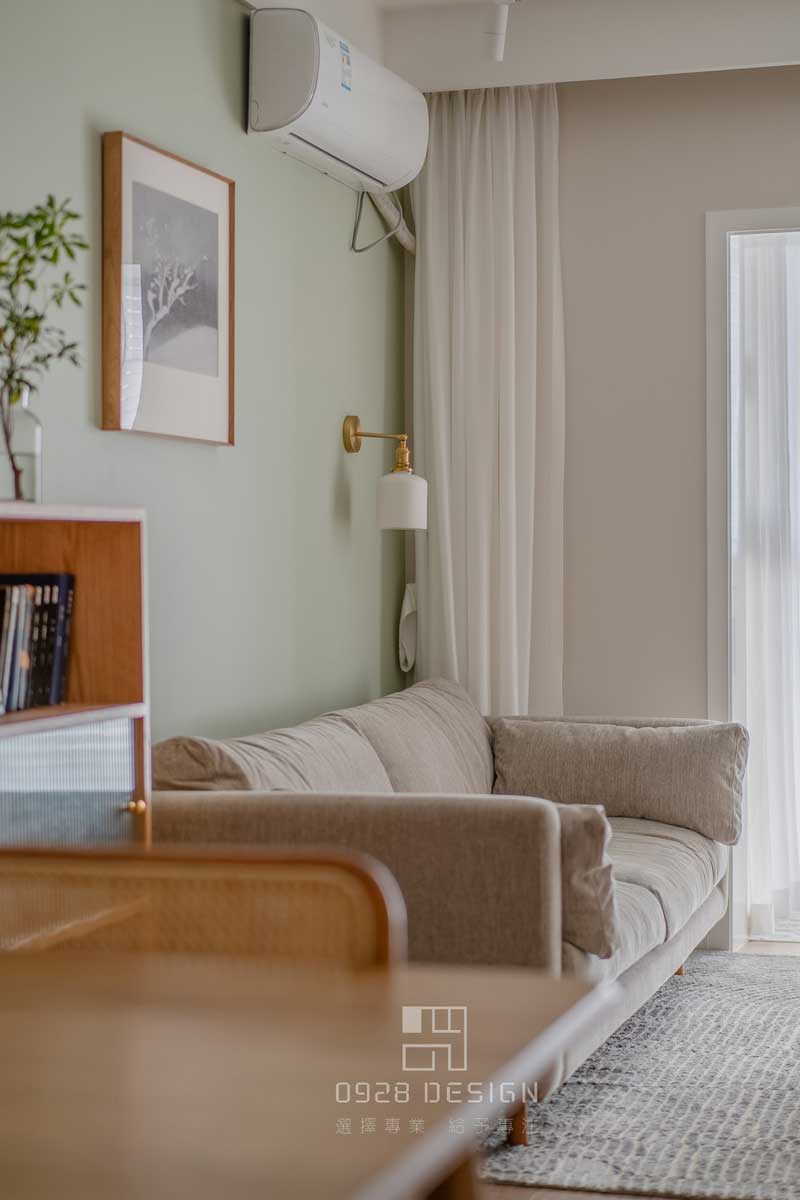 沙發(fā)背景灰綠色的墻面，增加了一點俏皮感，在沙發(fā)背景掛畫的選擇上沒有用常規(guī)的形式，單一幅正方形的雪景圖，加深了深遠悠長的感受。壁燈選擇瓷器的燈罩和金色的吊桿，點綴精致感又帶有復(fù)古的意味，和餐廳吊燈是一套購買。